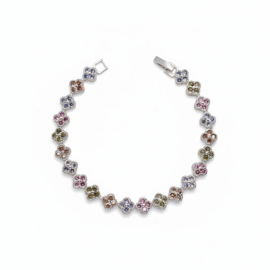 A silver-toned clover bracelet featuring multiple small gemstone clusters in pink, blue, green, and brown tones, displayed on a clean white background.