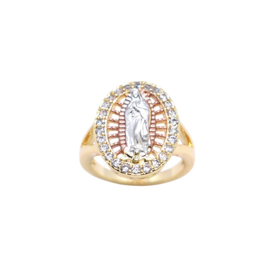 A gold ring featuring a central silver-toned religious figure surrounded by a halo of small clear stones, with a red-orange sunburst pattern in the background.