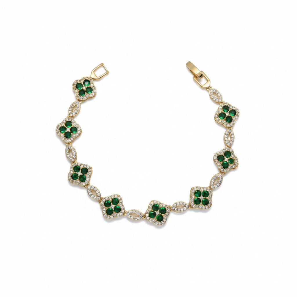 A gold plated bracelet featuring five floral clusters of green emeralds surrounded by pavé-set clear stones, displayed on a clean white background.