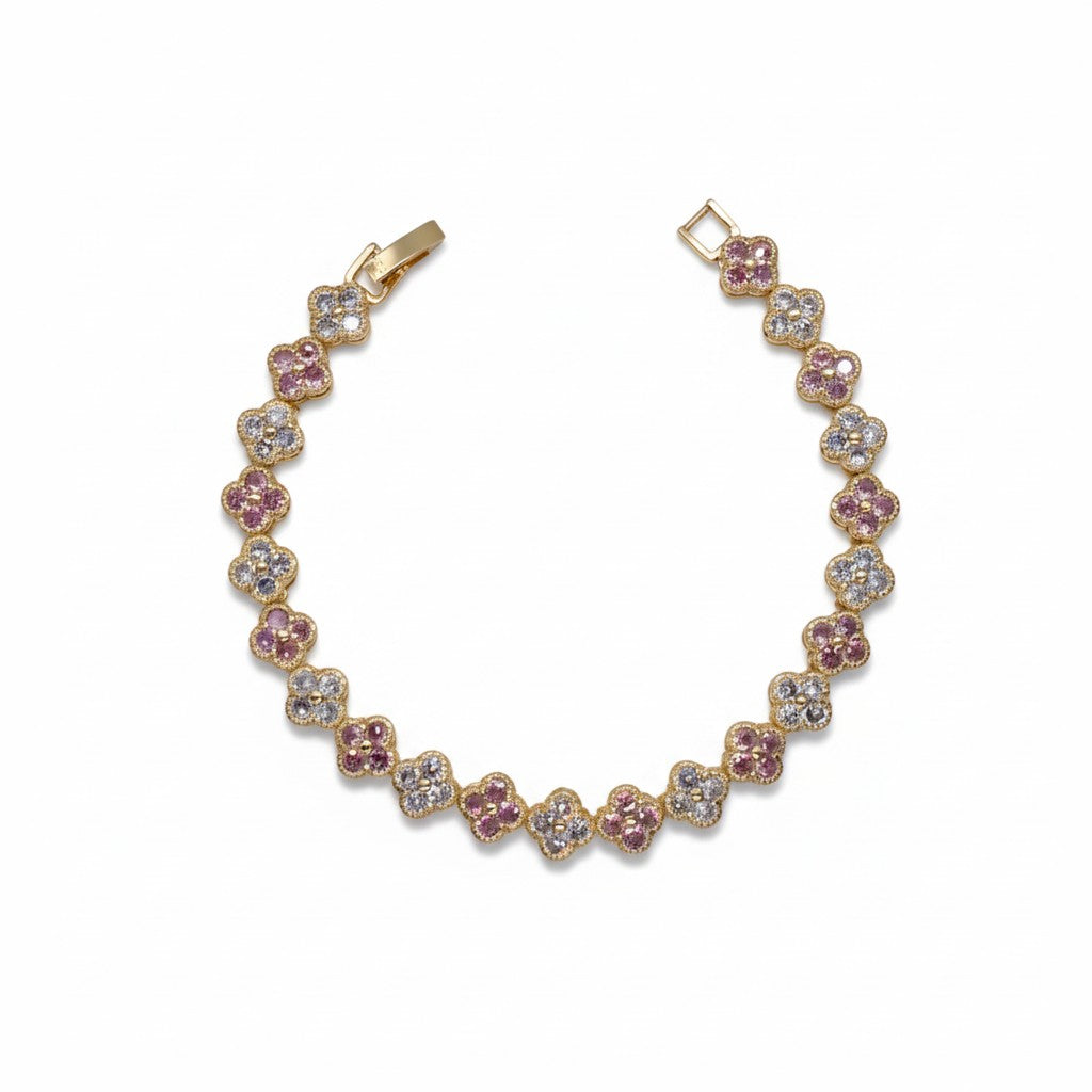 A gold-plated tennis bracelet featuring alternating floral clusters of pink and clear gemstones, displayed on a clean white background.