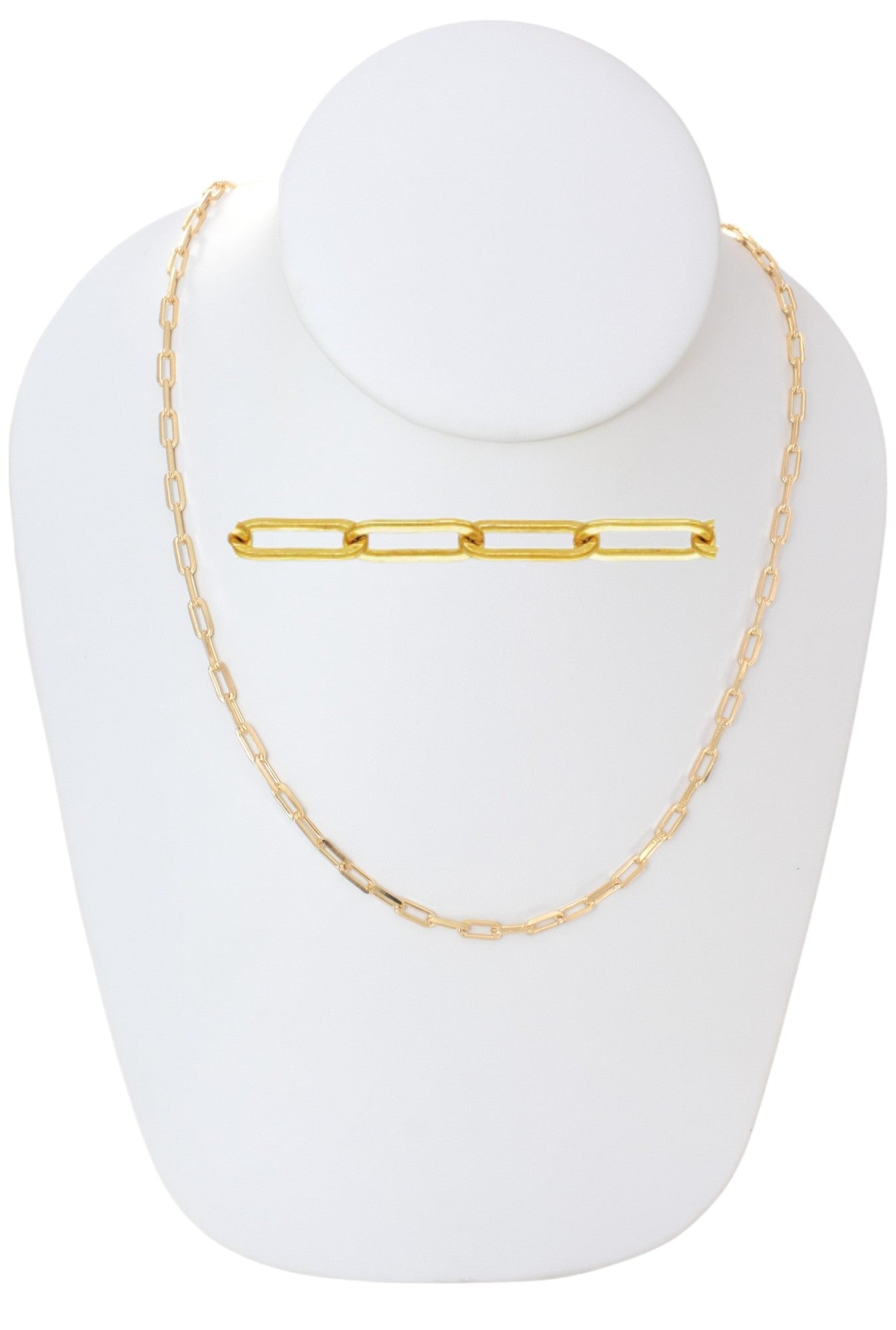 Gold paperclip chain necklace displayed on a white jewelry stand.